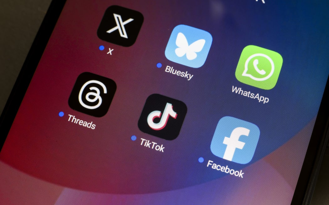 The logos of the social networks X (Twitter), Bluesky, WhatsApp, Threads, TikTok, and Facebook are displayed on the screen of a smartphone in Reno, United States, on November 20, 2024. (Photo by Jaque Silva/NurPhoto) (Photo by Jaque Silva / NurPhoto / NurPhoto via AFP)