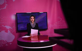 Afghan presenter Diba Akbari, 21, takes part in a live news broadcast for Zan TV (Women's TV) in Kabul on 18 February, 2019.