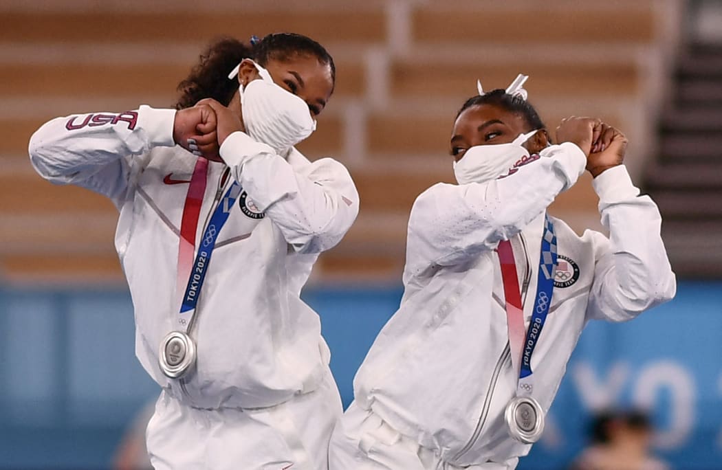 Silver medalists USA's Jordan Chiles and USA's Simone Biles celebrate on the podium of the artistic gymnastics women's team final during the Tokyo 2020 Olympic Games at the Ariake Gymnastics Centre in Tokyo on July 27, 2021.