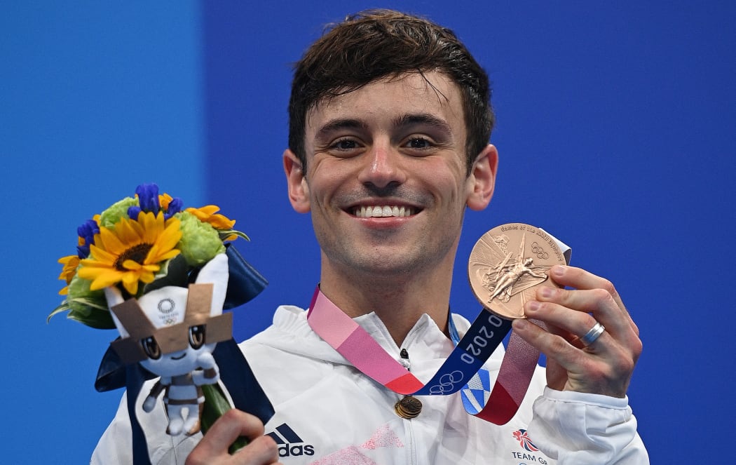 Bronze medallist Britain's Thomas Daley poses with their medal during the medal presentation ceremony after the men's 10m platform diving final event during the Tokyo 2020 Olympic Games at the Tokyo Aquatics Centre in Tokyo on August 7, 2021.