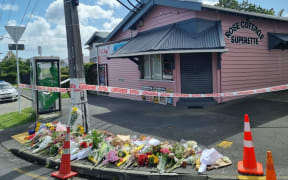 Flowers are seen outside Rose Cottage Superette in Sandringham, Auckland, after the fatal stabbing of a dairy worker on Wednesday, 23 November, 2022.