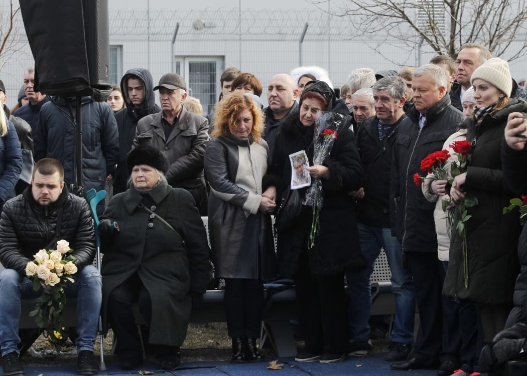 People pay tribute during a ceremony of a foundation stone for a future memorial and the square to memory the victims of the Ukraine International Airlines flight PS752 plane crash, at the Boryspil International Airport near Kyiv, Ukraine, on 17 February, 2020.
