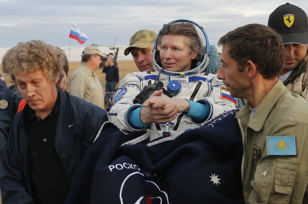Expedition 44 crew member Gennady Padalka (centre) of Roscosmos is carried to the medical tent after landing in a remote area outside the town of Zhezkazgan in Kazakhstan on 12 September 2015.
