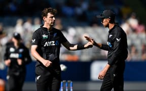 New Zealand's Matt Henry (L) and Mitchell Santner.