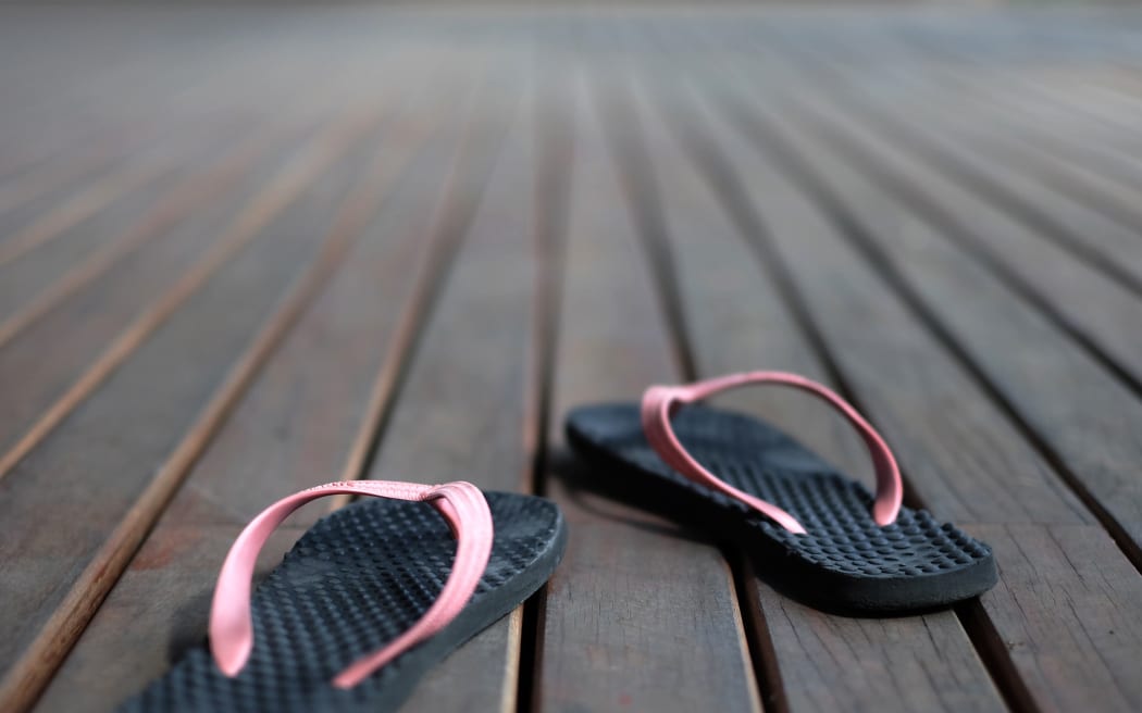 Jandals on wooden floor.