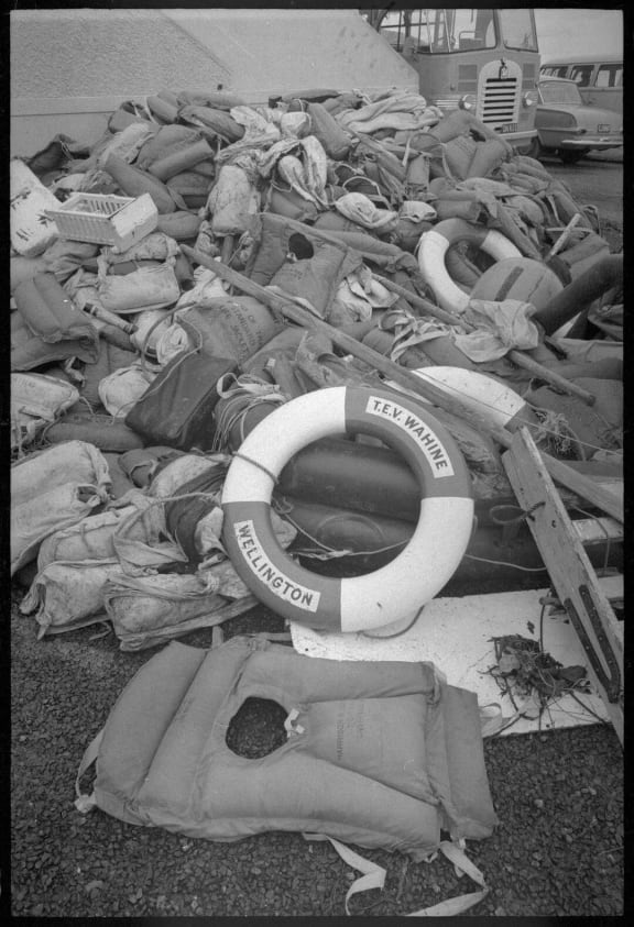 Life raft and wreckage from the Wahine, washed up on Eastbourne beach after the ship sank on 10 April 1968, photographed 11 April 1968 by an Evening Post staff photographer.