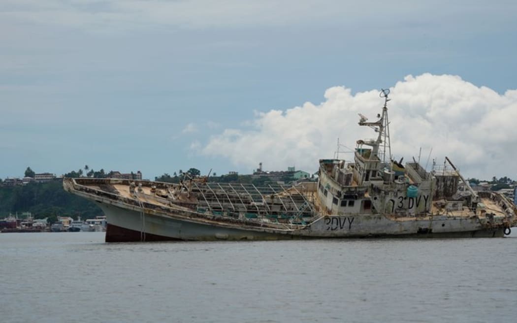 Fishing vessel Second Chance (3DVY) aground in the harbor with Suva’s central business district and the Republic of Fiji Naval Service (RFNS) Stanley Brown Base in the background. Pictured on Feb 14, 2025. (Harry Pearl/Benar News)