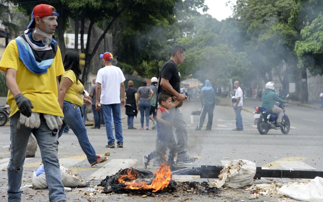 Demonstrators block a street in Caracas during a protest against Venezuelan President Nicolas Maduro.