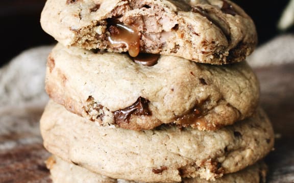 A stack of chocolate caramel Easter egg and tamari almond-studded cookies