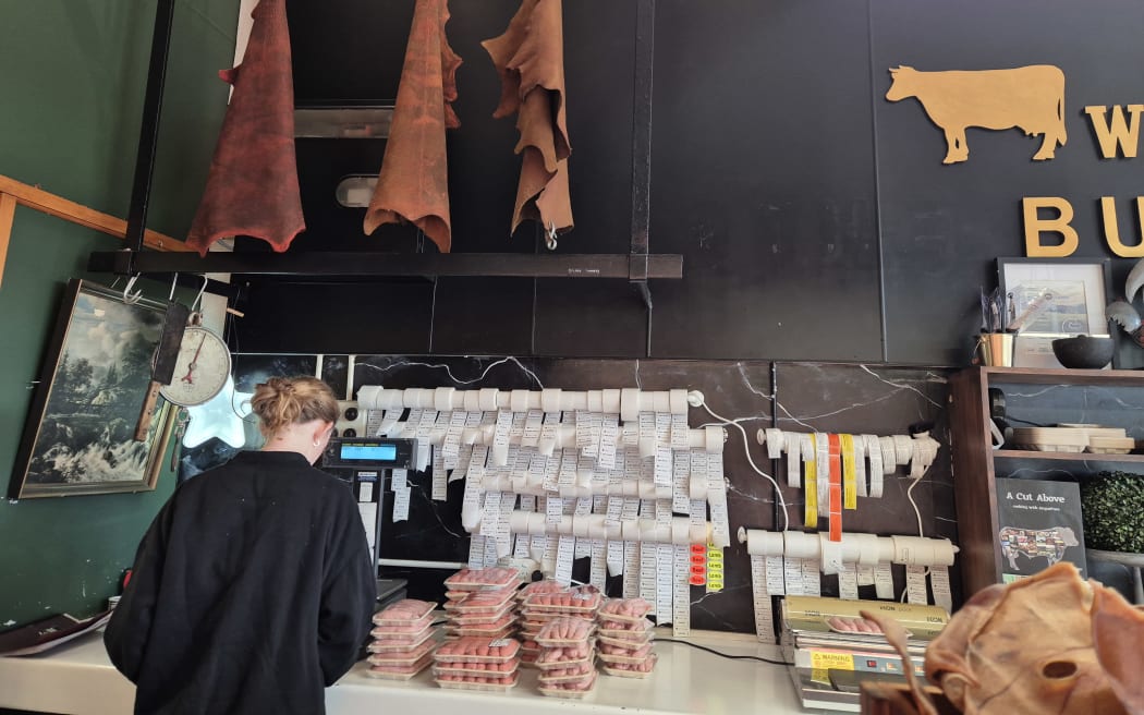 Some of the tanned sheepskins hang on display in the butcher's store.