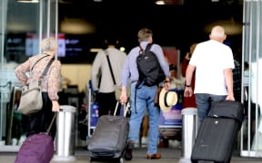 Passengers enter the international terminal departures area at Auckland Airport on 11 December 2024.