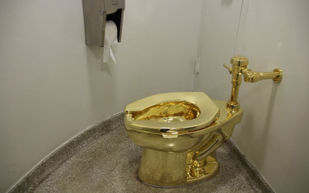 The fully functional 'America' toilet made from 18-karat gold has been opened in the Guggenheim Museum in Manhattan, New York City, USA, 16 September 2016. The toilet can and is to be used, but was also designed to be an artwork by Italian artist Maurizio Cattelan. Photo: CHRISTINA HORSTEN/dpa