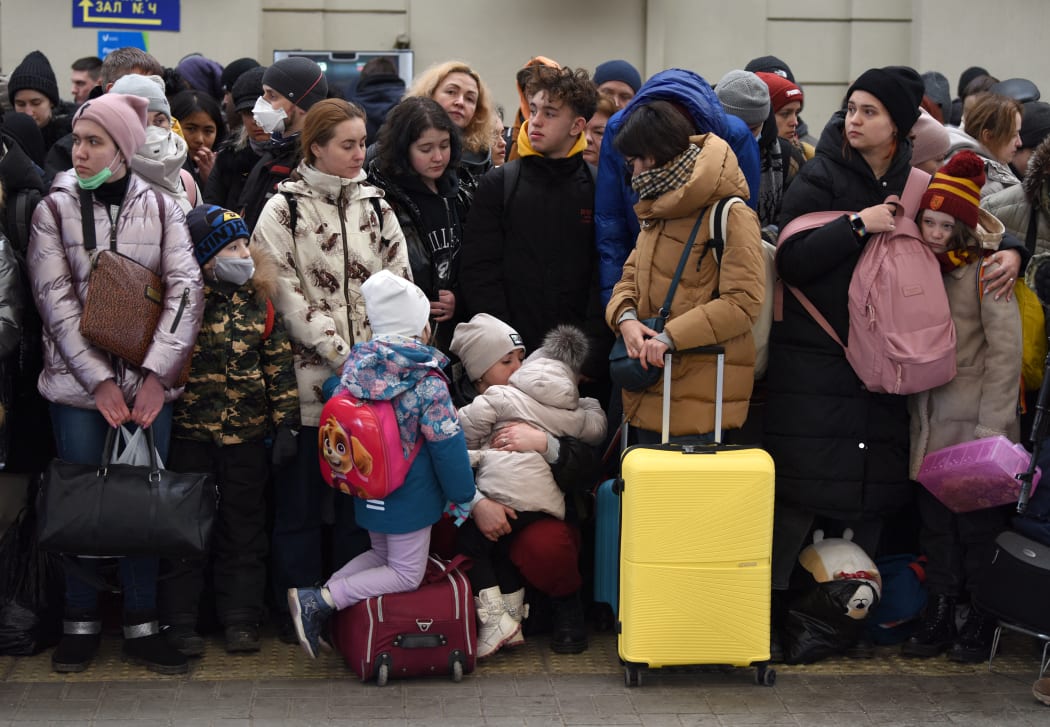 People wait for a train to Poland at the railway station of the western Ukrainian city of Lviv on February 26, 2022.