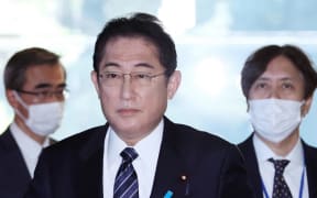 Japanese Prime Minister Fumio Kishida walks for speaking to media about COVID-19 at the prime minister’s office in Tokyo on January 20, 2023. PM Kishida plans to review the classification of the new coronavirus under the Infectious Diseases Act.( The Yomiuri Shimbun ) (Photo by Masanori Genko / Yomiuri / The Yomiuri Shimbun via AFP)