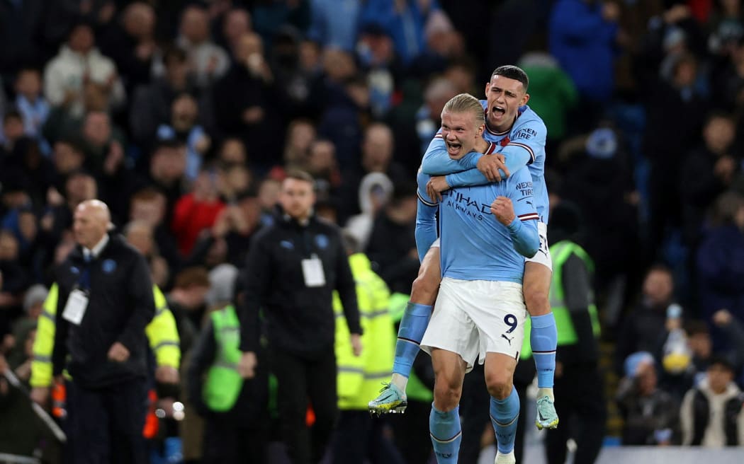 Manchester City's Norwegian striker Erling Haaland (L) celebrates scoring the team's second goal from the penalty spot during the English Premier League football match between Manchester City and Fulham at the Etihad Stadium in Manchester, north west England, on November 5, 2022. (Photo by ADRIAN DENNIS / AFP) / RESTRICTED TO EDITORIAL USE. No use with unauthorized audio, video, data, fixture lists, club/league logos or 'live' services. Online in-match use limited to 120 images. An additional 40 images may be used in extra time. No video emulation. Social media in-match use limited to 120 images. An additional 40 images may be used in extra time. No use in betting publications, games or single club/league/player publications. /
