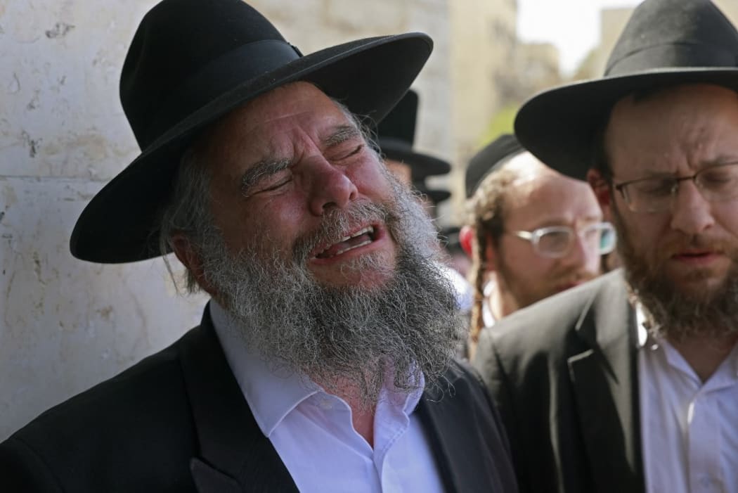 Ultra-Orthodox Jewish men react during a funeral ceremony in Jerusalem for Eliezer Goldberg who died in a stampede overnight during a religious gathering in northern Israel, on April 30, 2021.