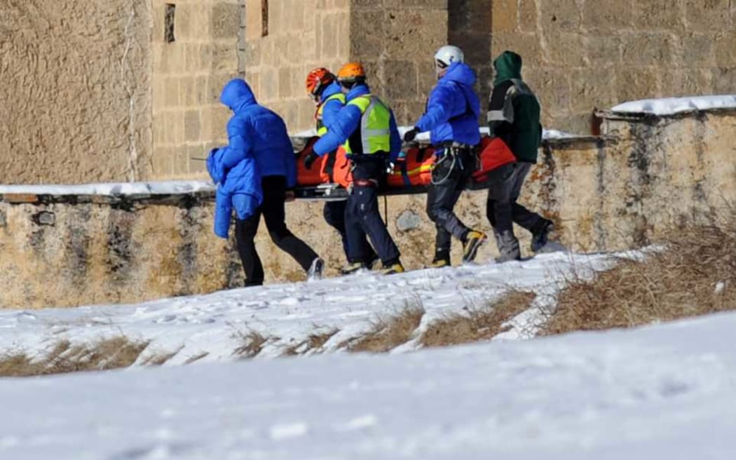 French rescuers carry the body of one of victims of the avalanche in the French Alps.