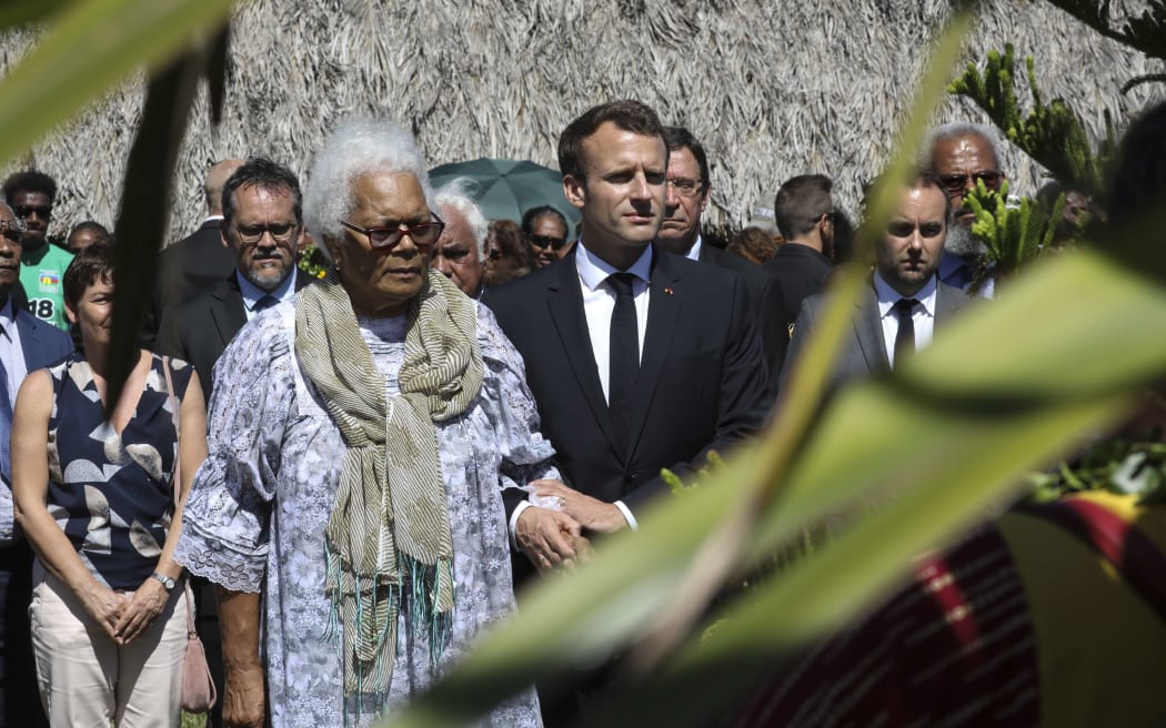 French President Emmanuel Macron walks with Marie Claude Tjibaou, the widow of Jean Marie Tjibaou, the Kanak separatist leader who was killed in 1988.
