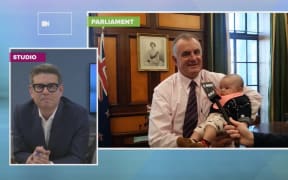 Trevor Mallard talks to John Campbell while holding MP Kiri Allan's baby Hiwi-i-te-Rangi.