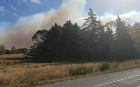 Smoke from the fire that is threatening homes in Teapot Valley today.