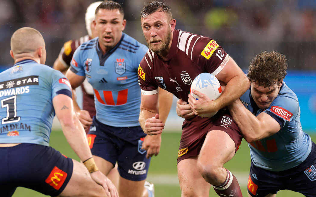 Kurt Capewell of the Maroons is tackled by Liam Martin of the Blues during the State of Origin game two match.