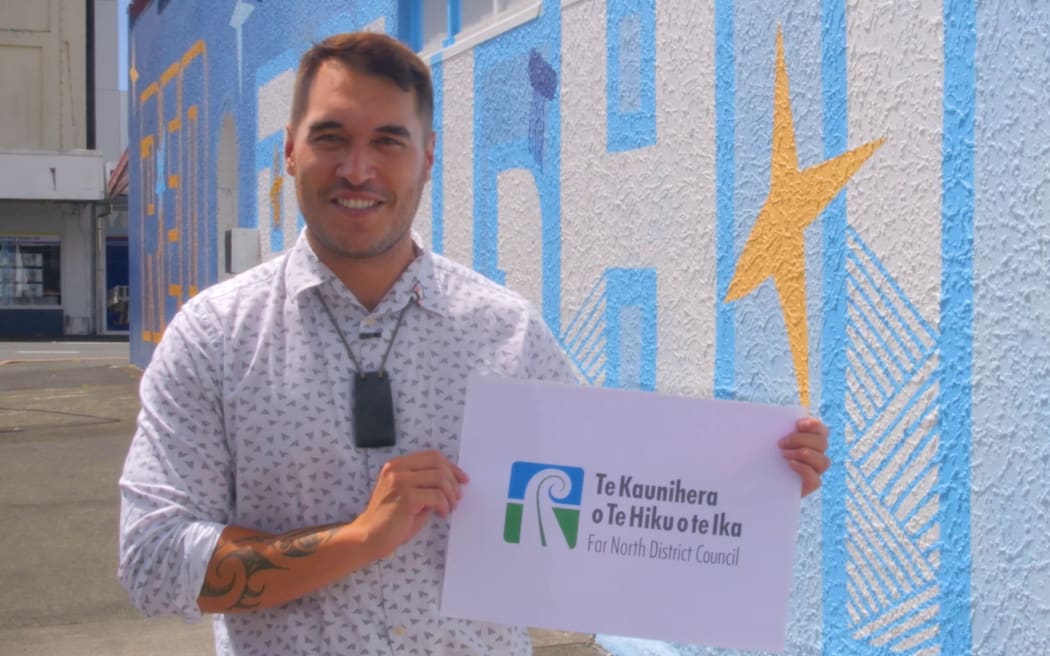 Far North Mayor Moko Tepania with the council’s updated logo and restored te reo name, Te Hiku o te Ika (The Tail of the Fish). Photo: Supplied / FNDC