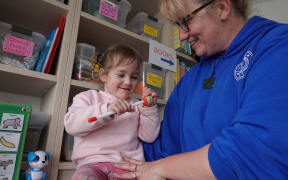 Julia Tiffen, with her grandmother Pip Cook, at the Little Stars centre's new home.