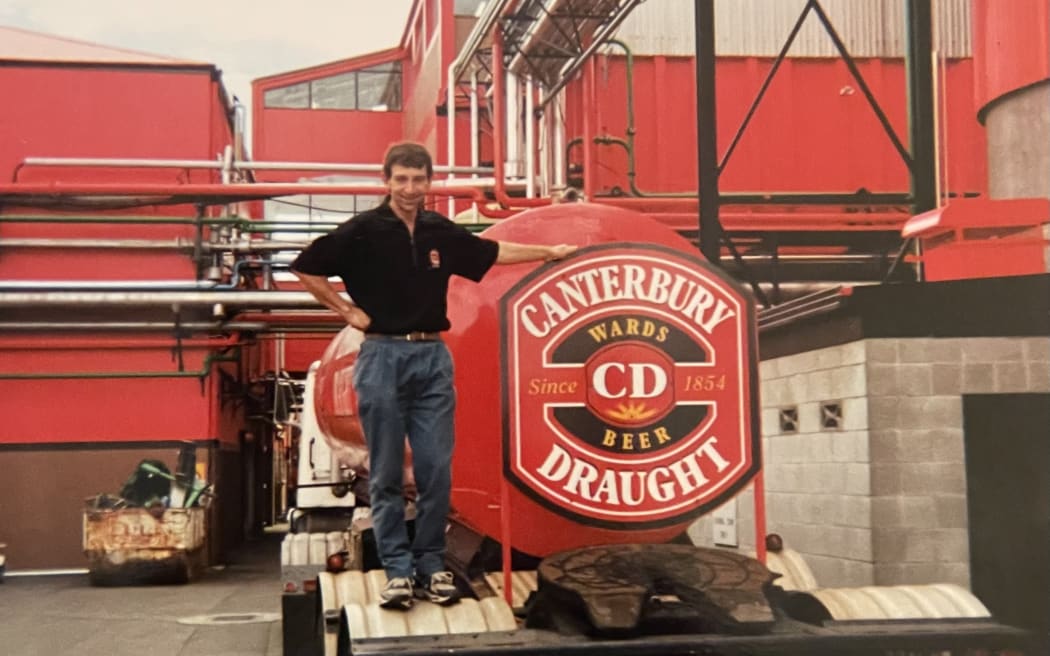 Denise Garland's father Colin, standing next to a Canterbury Draught branded tanker.