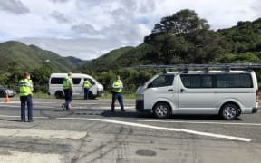 Police officers question drivers at a lockdown checkpoint near Featherston.