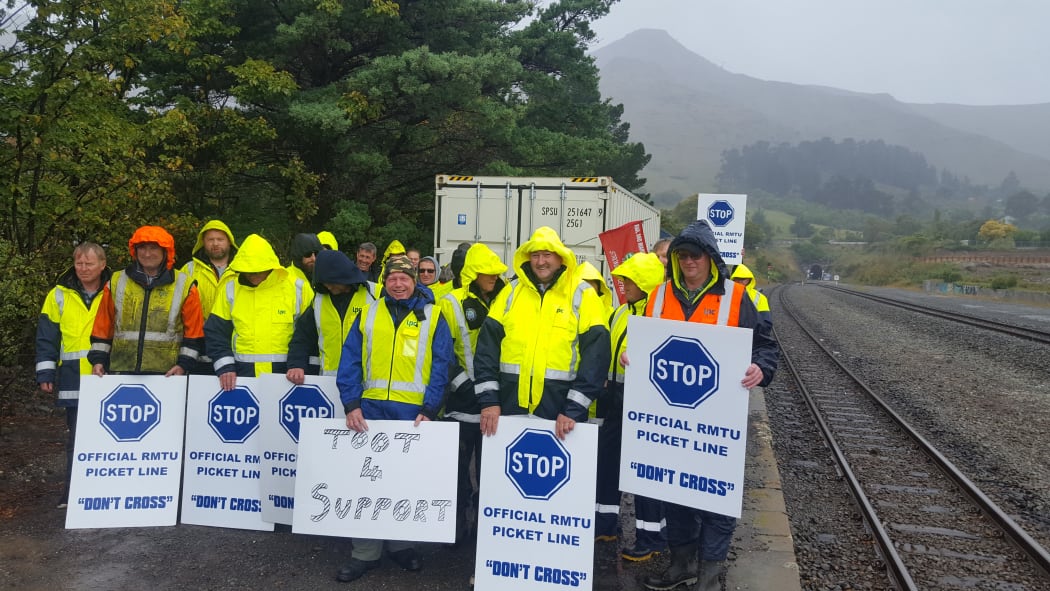 Picketing workers near rail tunnel entrance