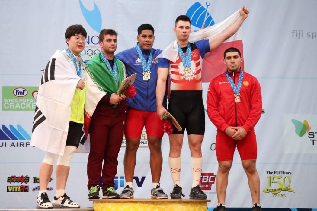 Don Opeloge celebrates won two gold medals at the 2019 Junior World Weightlifting Championships.