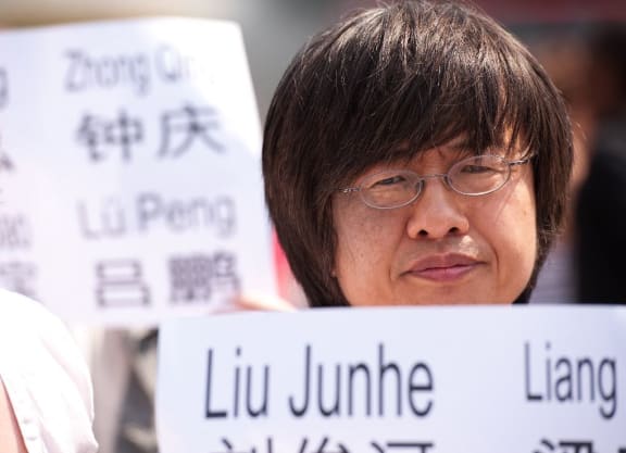 Tiananmen Square massacre survivor Shao Jiang holds a sign as a group gathers in Trafalgar Square, central London on June 4, 2011 to mark the 22nd anniversary of the Tiananmen Square massacre in China in 1989.