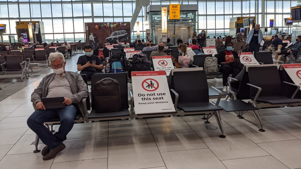 Passengers wait for flights in the Heathrow Airport in London.