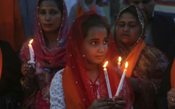 Pakistani citizens light candles at a vigil for the victims of bomb explosions in churches and hotels in Sri Lanka, in Lahore, Pakistan, Tuesday April 23, 2019.