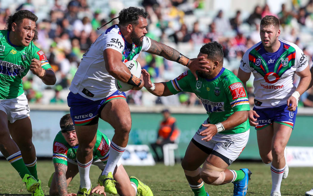 The Warriors Ben Murdoch-Masila puts out a fend against the Raiders.