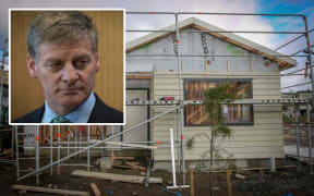 Prime Minister Bill English (insert) and a house under construction