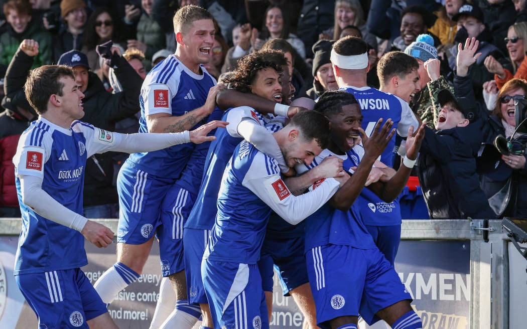 Macclesfield's English striker #07 Isaac Buckley-Ricketts (R) celebrates with teammates after scoring the team's second goal during the English FA Cup third round football match between Macclesfield Town and Crystal Palace at Leasing.com Stadium, Moss Rose in Macclesfield, northern England on January 10, 2026. (Photo by Darren Staples / AFP) / RESTRICTED TO EDITORIAL USE. NO USE WITH UNAUTHORIZED AUDIO, VIDEO, DATA, FIXTURE LISTS, CLUB/LEAGUE LOGOS OR 'LIVE' SERVICES. ONLINE IN-MATCH USE LIMITED TO 120 IMAGES. AN ADDITIONAL 40 IMAGES MAY BE USED IN EXTRA TIME. NO VIDEO EMULATION. SOCIAL MEDIA IN-MATCH USE LIMITED TO 120 IMAGES. AN ADDITIONAL 40 IMAGES MAY BE USED IN EXTRA TIME. NO USE IN BETTING PUBLICATIONS, GAMES OR SINGLE CLUB/LEAGUE/PLAYER PUBLICATIONS. /
