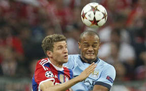 Thomas Mueller of Bayer n Munich and Vincent Kompany of Manchester City.