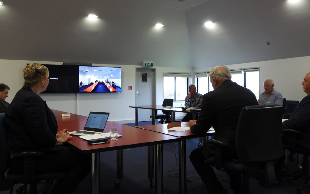 West Coast Regional Council representatives sit in silence moments before the start of today's extraordinary meeting to remove the chair.