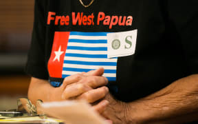 Maire Leadbeater wears a "Free West Papua" shirt as she answers questions on her petition urging the government to address human rights issues in West Papua.