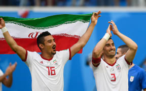 Iran footballers celebrate victory.