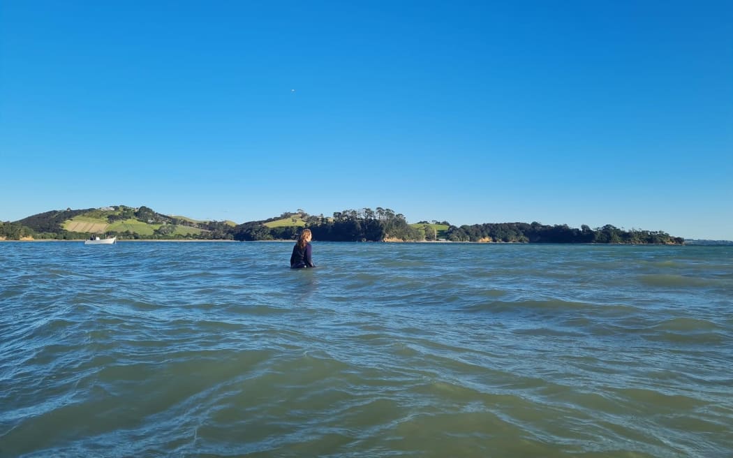 Rose Davis looks out to where she helped stranded dolphins refloat at Whakanewha on Waiheke Island.