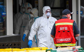 Members of the Melbourne Fire Brigade (MFB) prepare to take food parcels to residents in a locked down public housing estate in Melbourne on July 9, 2020 as the city re-enters a city wide lockdown after a fresh outbreak of the COVID-19 coronavirus.
