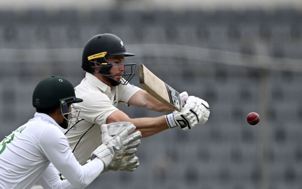 New Zealand's Glenn Phillips (R) plays a shot as Bangladesh’s wicketkeeper Nurul Hasan watches during the third day of the second Test cricket match between Bangladesh and New Zealand at the Sher-E-Bangla National Cricket Stadium in Dhaka on December 8, 2023. (Photo by Munir UZ ZAMAN / AFP)