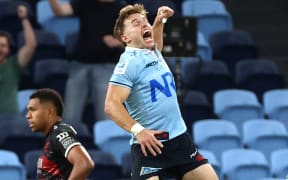 Waratahs’ Will Harrison celebrates after kicking a drop goal to win the game during the Super Rugby match between the New South Wales Waratahs and the Crusaders at Allianz Stadium in Sydney on April 12, 2024. (Photo by DAVID GRAY / AFP) / -- IMAGE RESTRICTED TO EDITORIAL USE - STRICTLY NO COMMERCIAL USE --