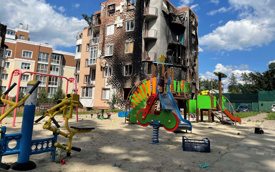 War ravaged apartment building with a playground