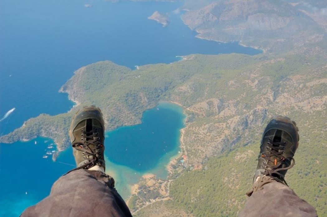 A paraglider with the Earth below his feet.