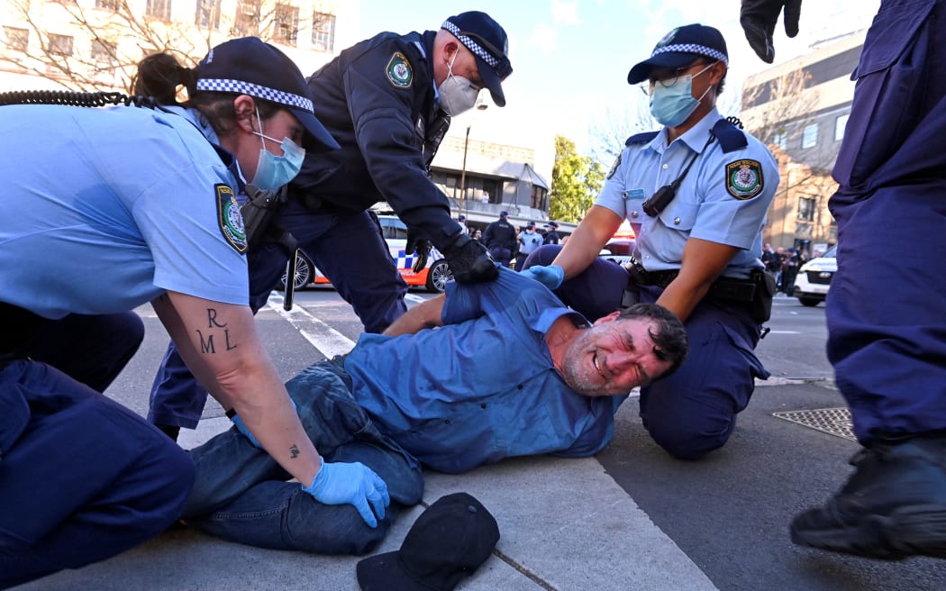 Police arrest a protester at a rally in Sydney