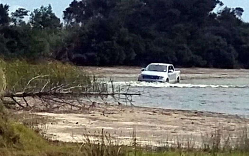 A 4WD being washed in Lake Waiporohita.
