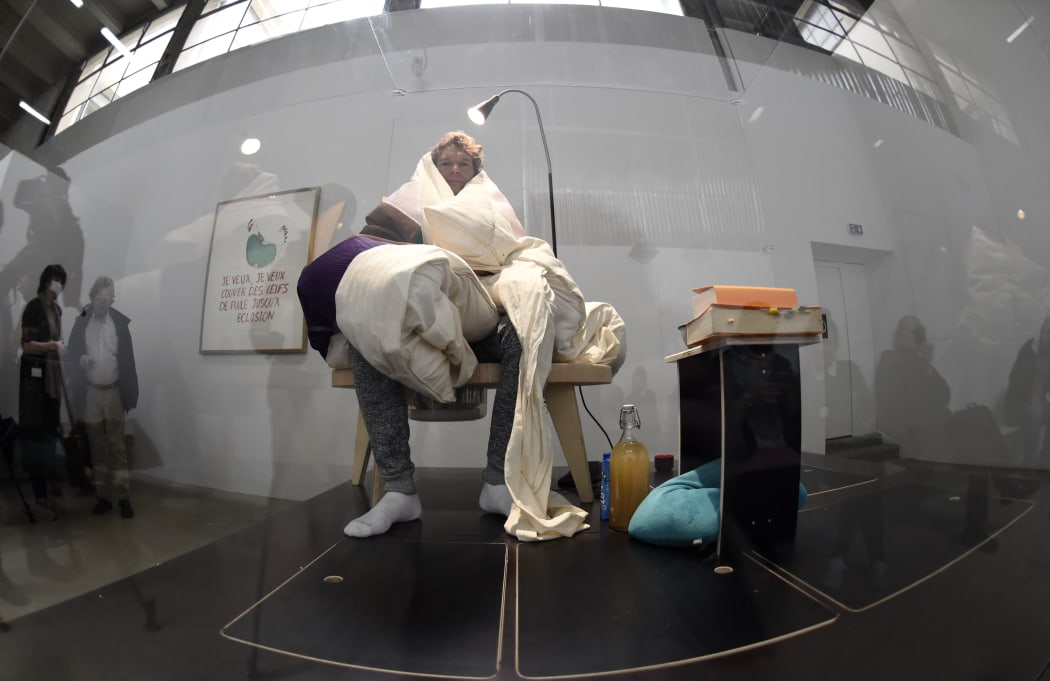 French artist Abraham Poincheval incubates eggs at the Palais de Tokyo musuem in Paris.